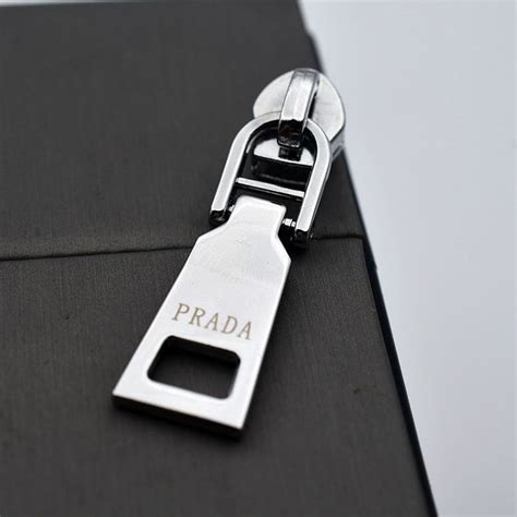 prada zipper engraved|Prada zipper pull.